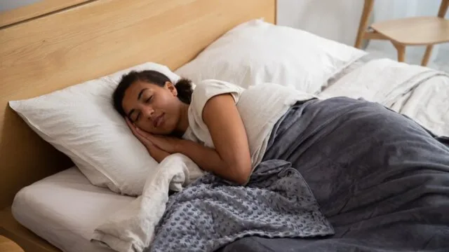 Woman peacefully sleeping in bed calming bedtime routine