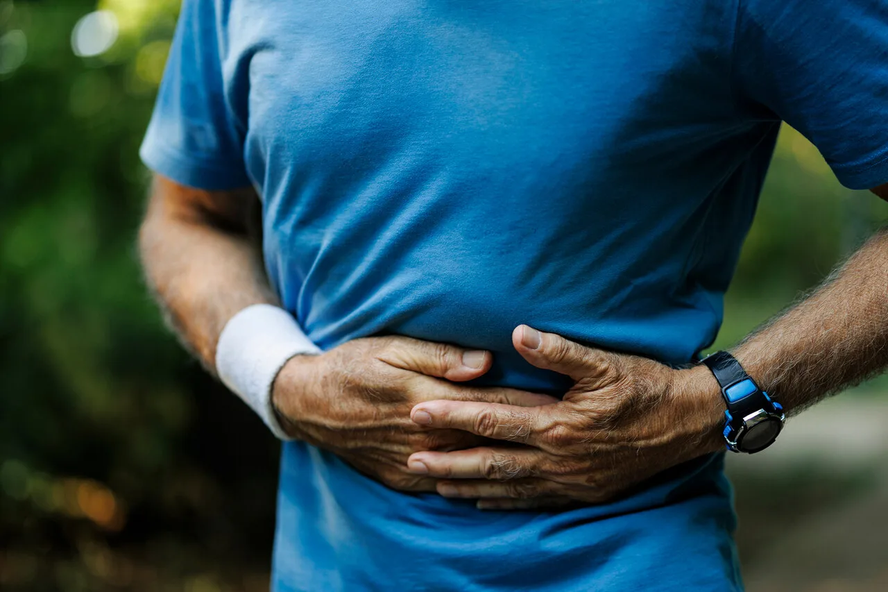 Runner holding side in pain from side stitch during exercise