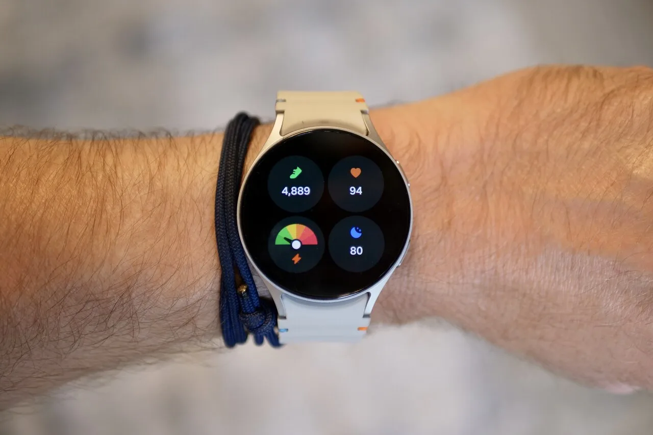 Smartwatch displaying fitness tracker metrics including steps heart rate and sleep score