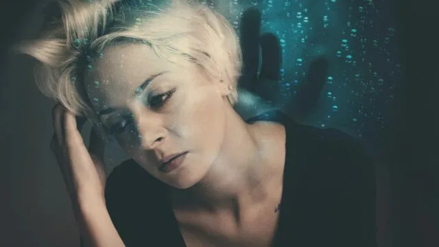 Woman experiencing self-doubt and impostor feelings during mindfulness practice