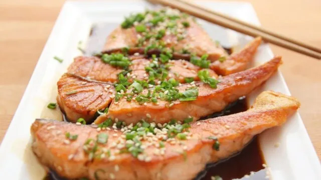 Grilled salmon meal with sesame seeds representing best foods for muscle recovery