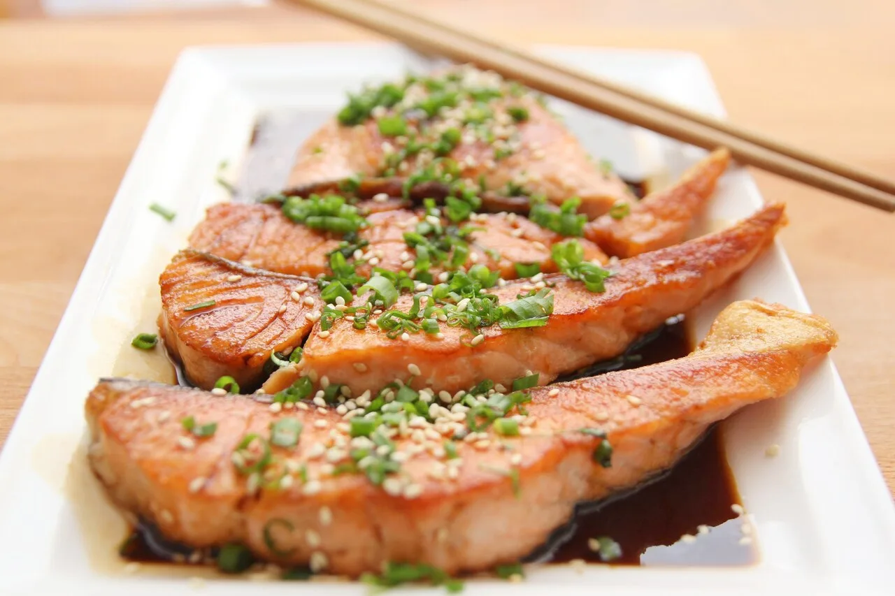Grilled salmon meal with sesame seeds representing best foods for muscle recovery