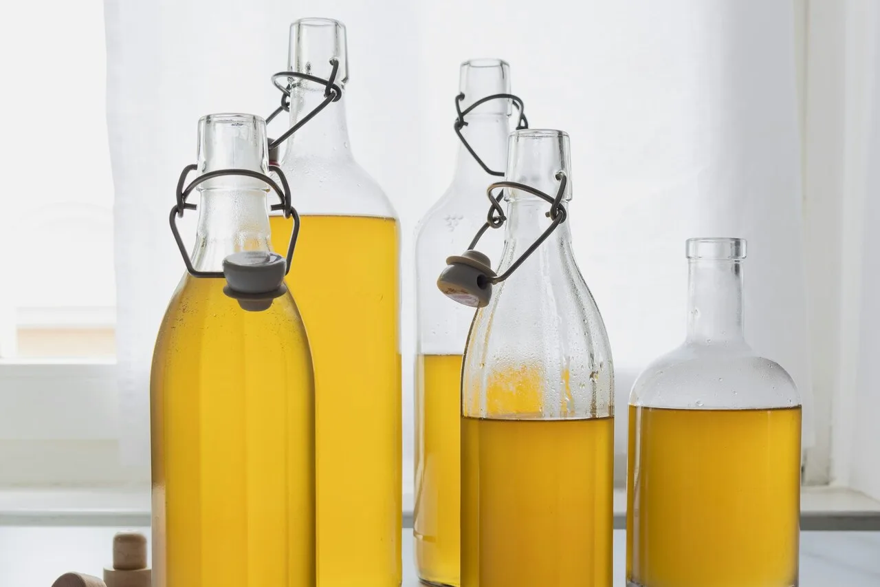 Glass bottles of seed oil representing health effects of cooking oils