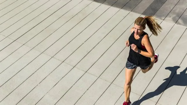 Woman running outdoors representing healthy lifestyle habits that boost life expectancy by 12 to 14 years