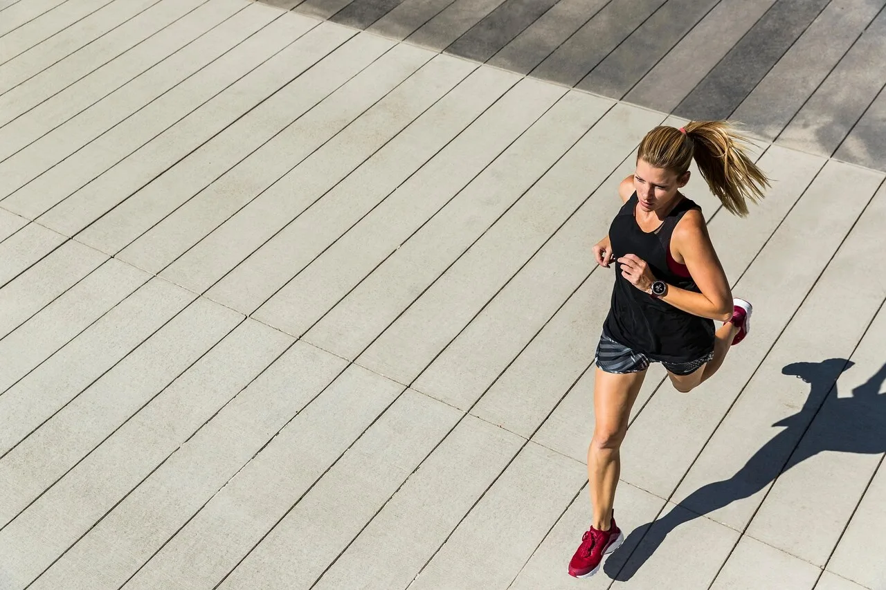 Woman running outdoors representing healthy lifestyle habits that boost life expectancy by 12 to 14 years
