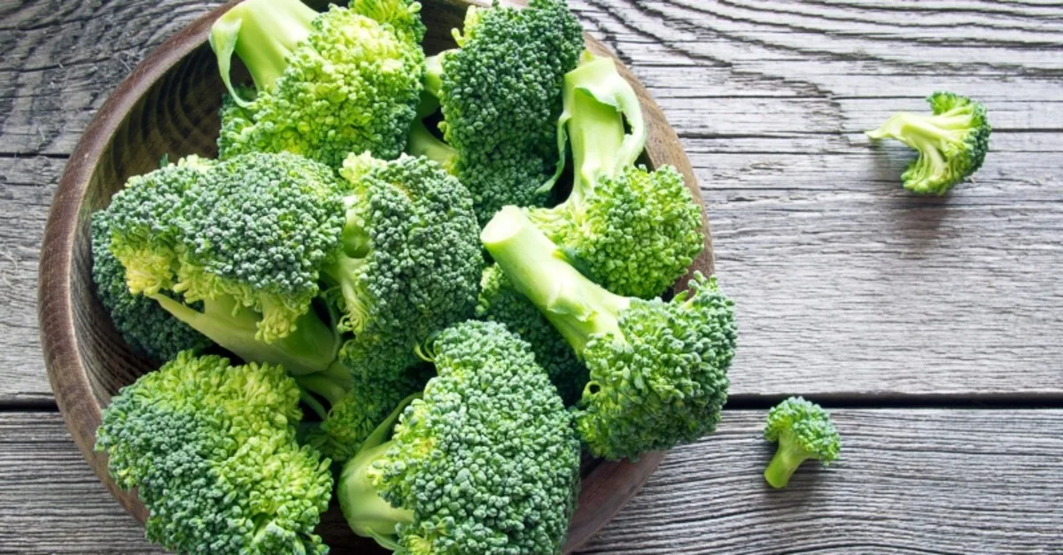 Fresh broccoli florets in a wooden bowl representing cruciferous vegetables that support liver detoxification and natural breast cancer prevention