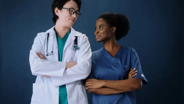 Diverse healthcare professionals including an Asian doctor and Black nurse representing inclusion and equity in clinical practice to address racial bias in medicine
