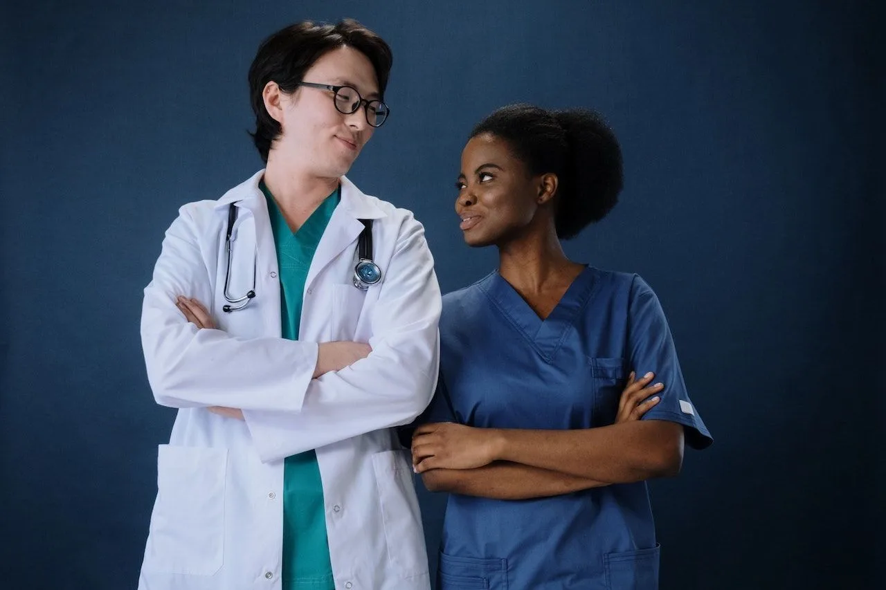 Diverse healthcare professionals including an Asian doctor and Black nurse representing inclusion and equity in clinical practice to address racial bias in medicine