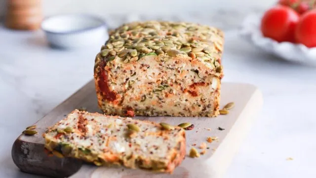 Sliced gluten-free quinoa bread with seeds on a wooden board as a healthy alternative for those with celiac disease or gluten sensitivity