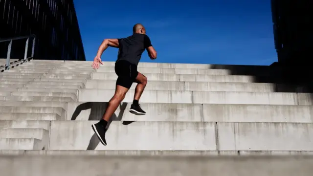 Person climbing stairs as a form of interval exercise after eating