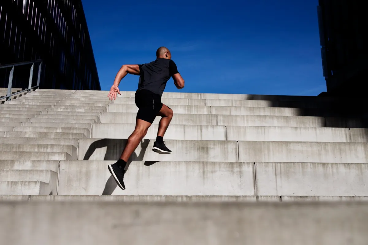 Person climbing stairs as a form of interval exercise after eating
